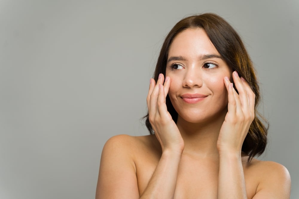 Woman,With,Perfect,Skin,Is,Touching,Her,Face,And,Smiling Facial Balancing with Botox and Filler in Nampa, Idaho: Pricing and Results Guide